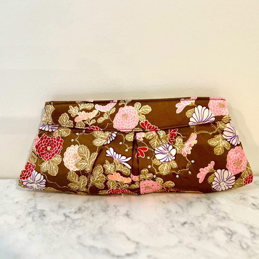 Satin brown, gold, pink floral clutch with gold embellishment.